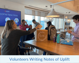 Volunteers handwriting notes of uplift for the recipients of their kits