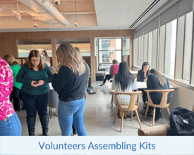 Volunteers assembling kits using the Building Impact technology platform