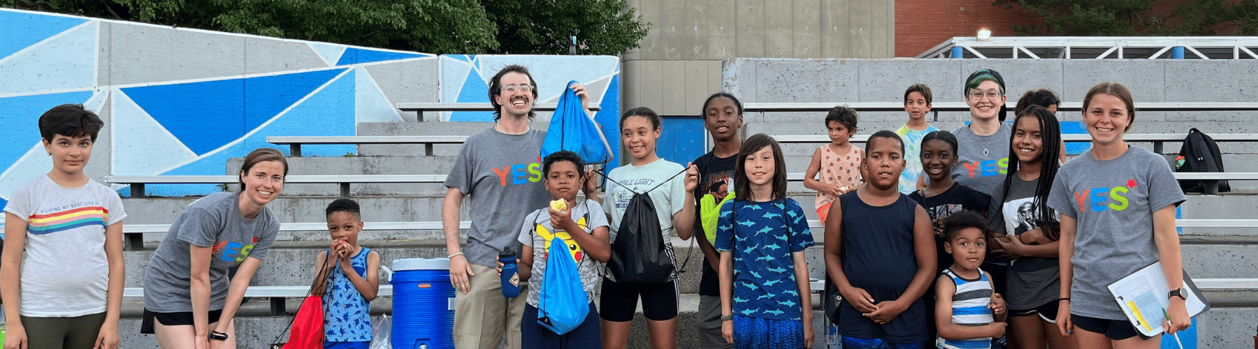 Group of youth participating in a summer fitness programming holding up Hydration and Nutrition Kits.