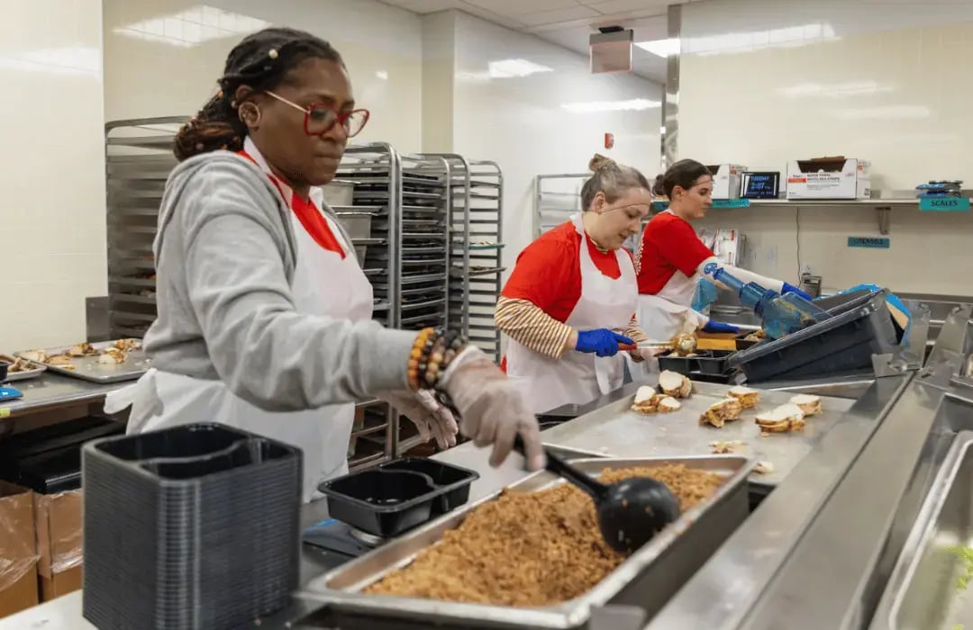 Volunteers preparing meals in a community kitchen