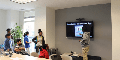 Youth from Boston Public Schools presenting the app idea they created at a 