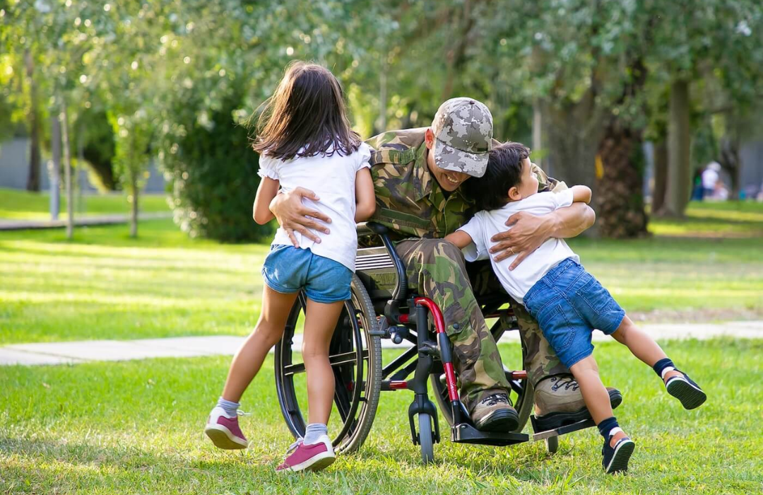 Disabled veteran embracing two children
