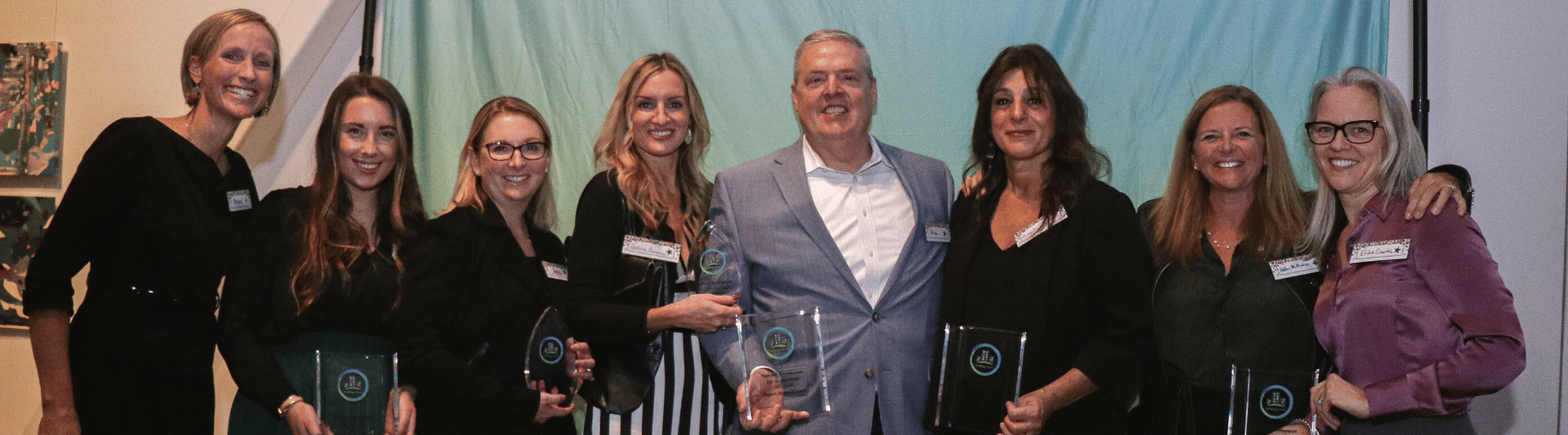 Leaders from National Development holding up their 2021 Impact Awards.